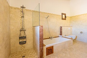 A bathroom with a walk in shower and a bathtub