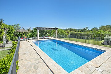 A large swimming pool with a fence around it