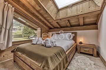A bedroom with a bed and a window with the word ter80 on the bottom