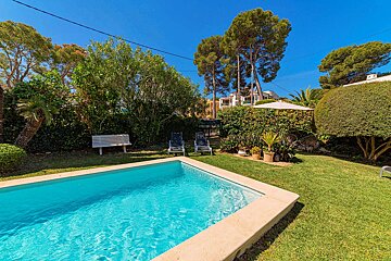 A large swimming pool surrounded by chairs and trees