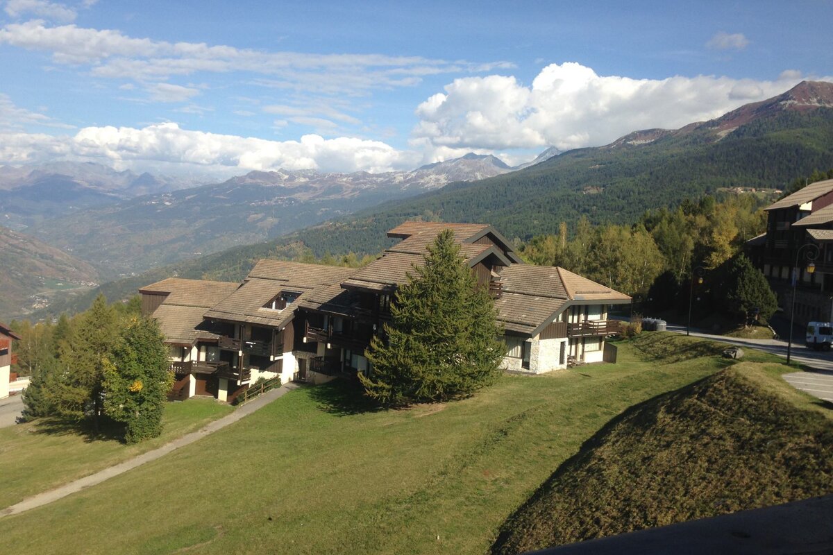 A view of a valley with mountains in the background