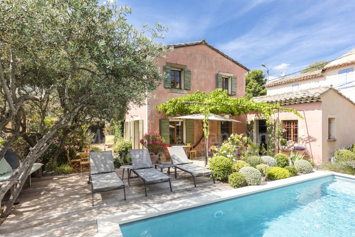 A house with a swimming pool in front of it