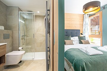 A bathroom with a toilet and a walk in shower