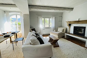 A living room with a fireplace and a white couch