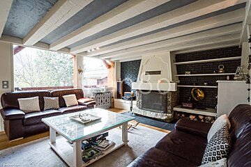 A living room with a couch a coffee table and a fireplace