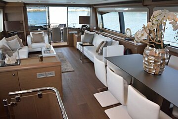 A living room with a table and chairs and a vase of flowers