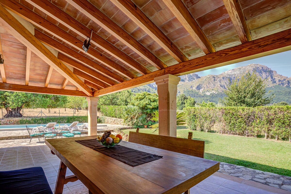 A wooden table with a bowl of fruit on it