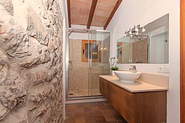 A bathroom with a sink and a walk in shower