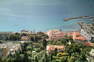 An aerial view of a city with the ocean in the background