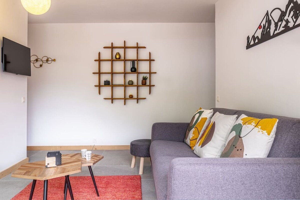 A living room with a couch a table and a tv