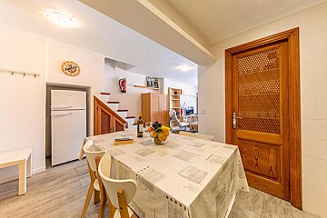 A kitchen with a table and chairs and a sign that says ' coca cola ' on it