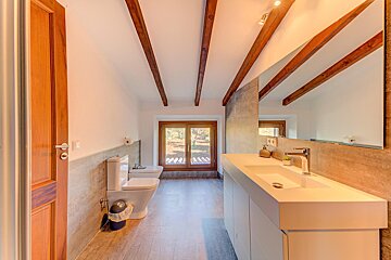 A bathroom with a toilet a sink and a mirror