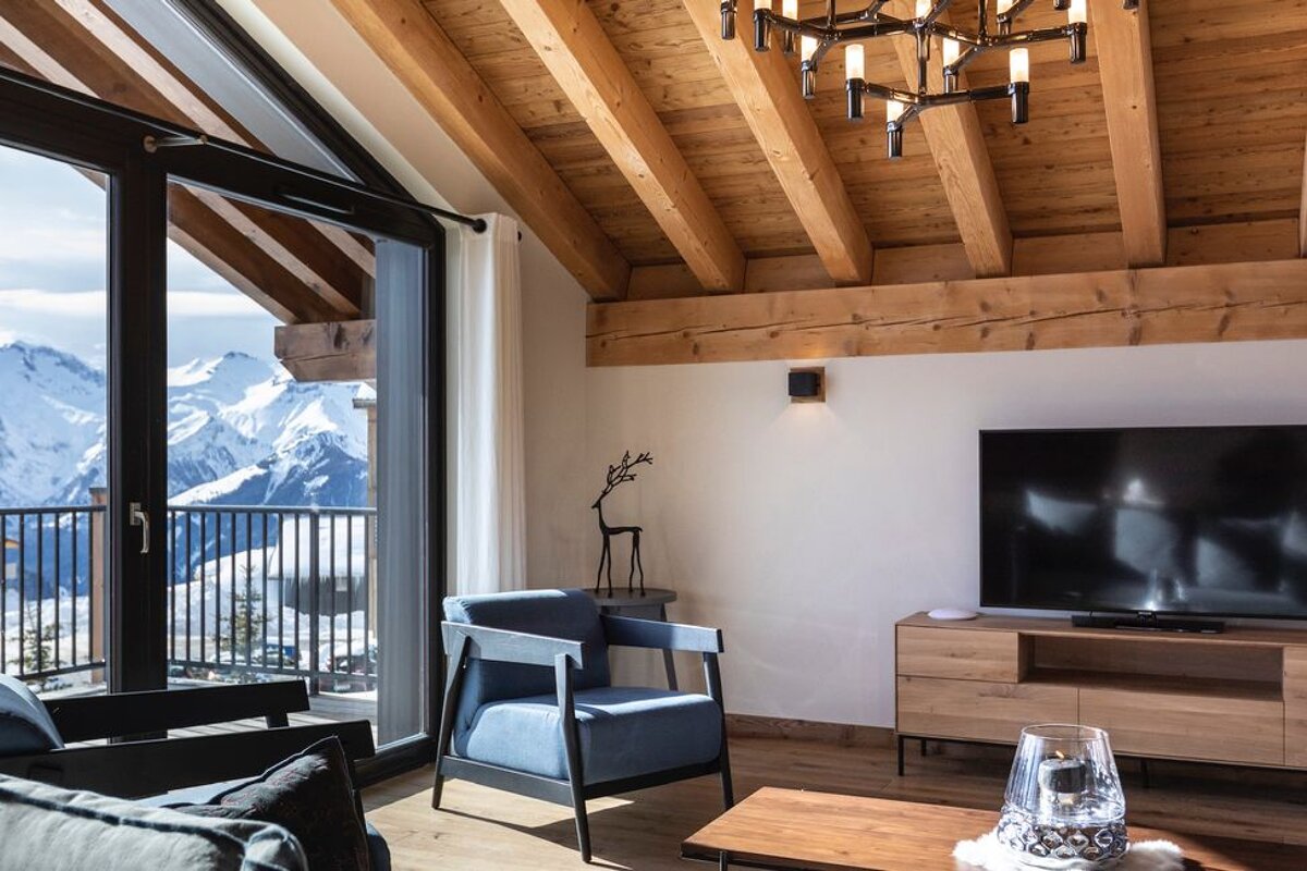 A living room with two chairs and a flat screen tv