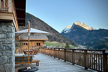A snowy mountain with a ski slope in the background