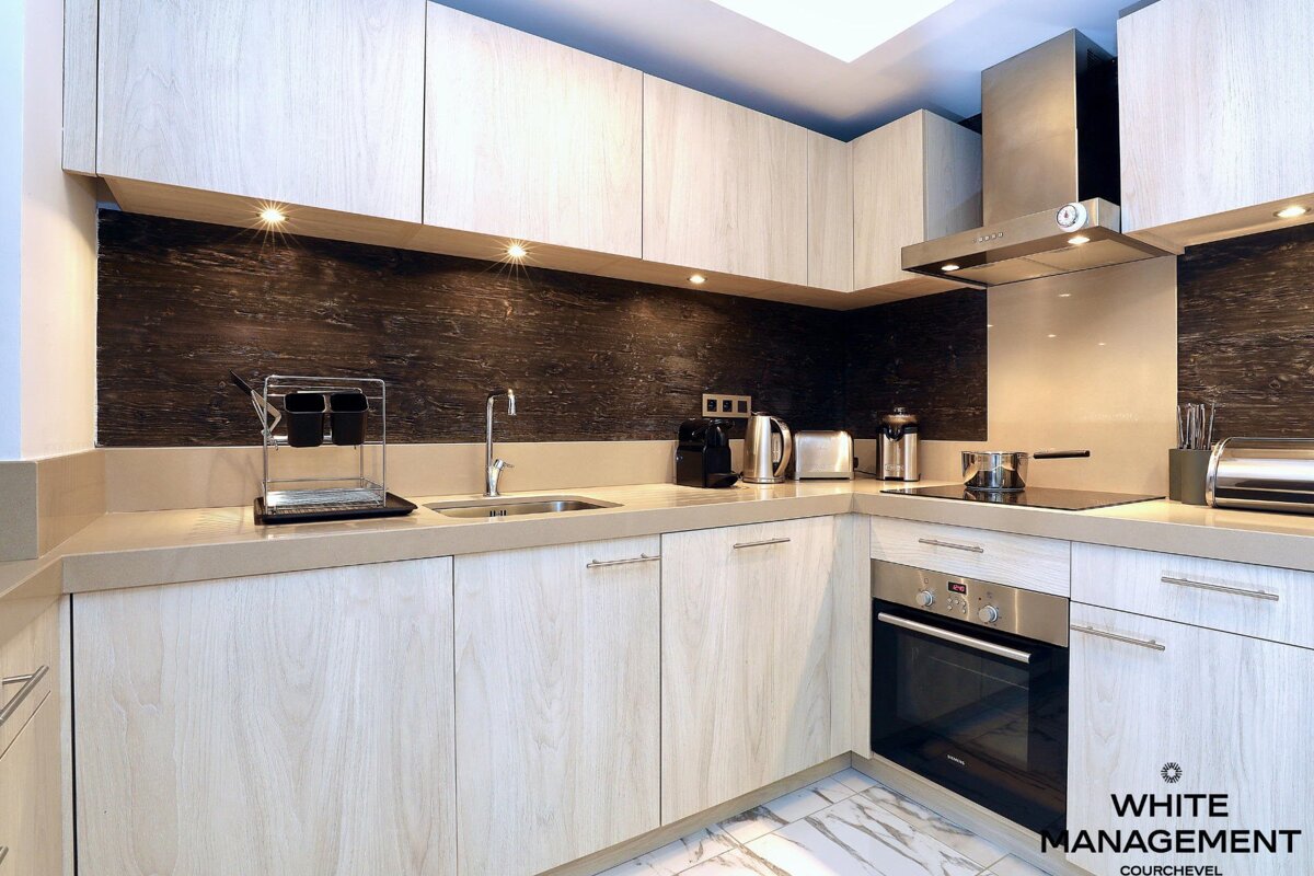 A kitchen with a sign that says portal designer luxury rental