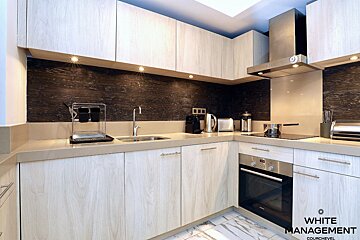 A kitchen with a sign that says portal designer luxury rental