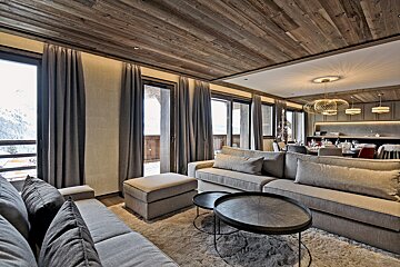 A living room with a couch and two tables