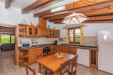 A kitchen with wooden cabinets and a white refrigerator
