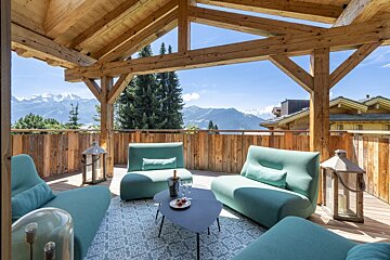 A balcony with a view of mountains and trees