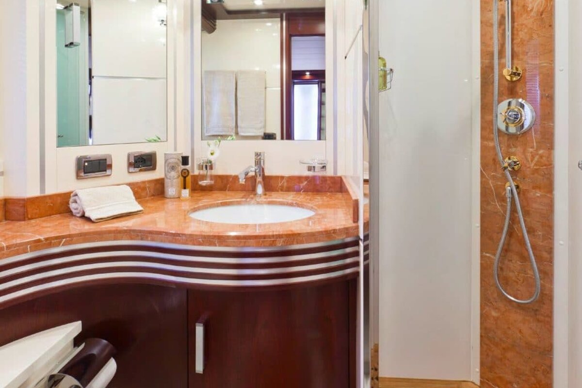 A bathroom with a sink a toilet and a shower