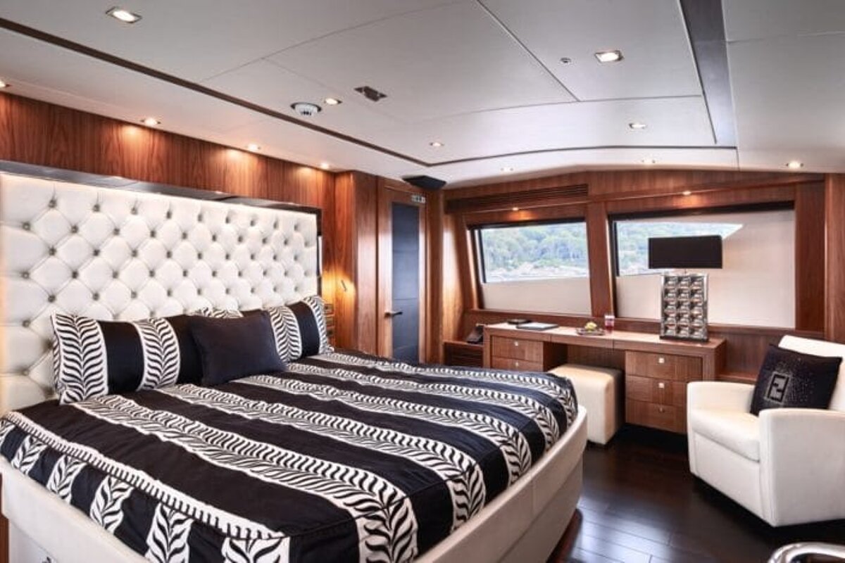 A bedroom with a black and white striped bed