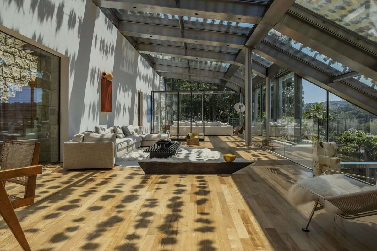 A living room with a lot of windows and furniture