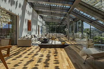 A living room with a lot of windows and furniture