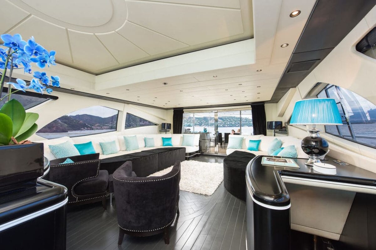 A living room on a boat with a couch and chairs