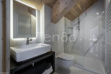 A bathroom with a sink and toilet with the number ten80 on the wall