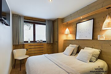 A bunk bed with a tv mounted on the wall above it