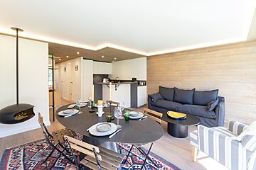 A kitchen with a table and chairs and a coffee maker