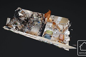 A complex 3D scan of a building's interior, showing labeled rooms like a garage, laundry, boiler room, WC, and apartment living/kitchen areas.