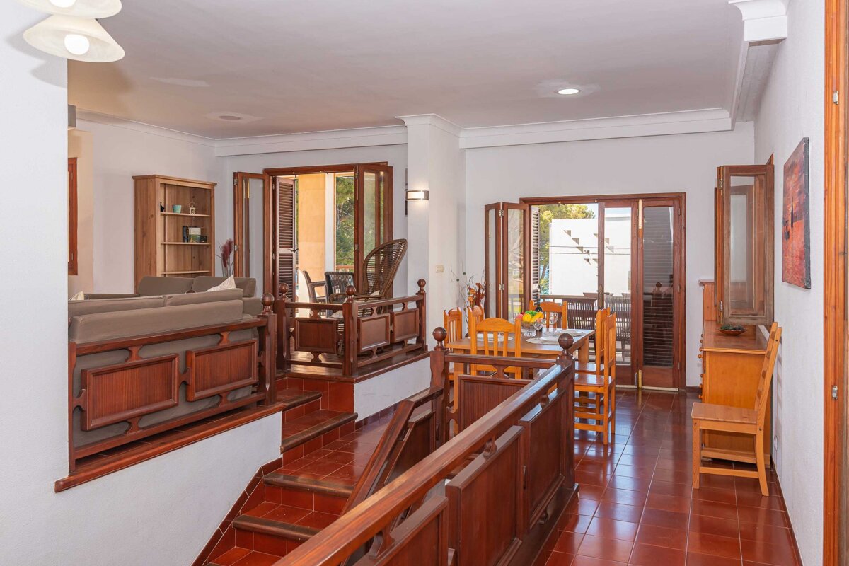 A living room with a staircase leading up to the second floor