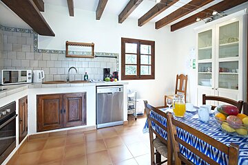 A kitchen with a stainless steel dishwasher and a microwave