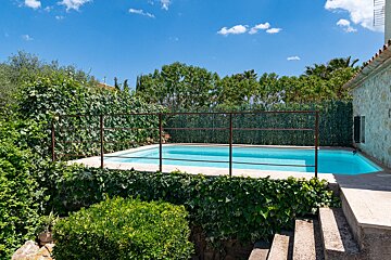 A large swimming pool with a fence around it