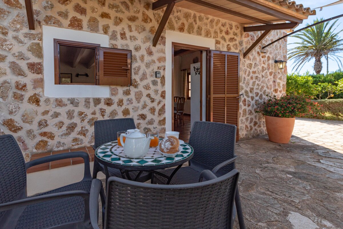 A table with a pitcher of orange juice on it