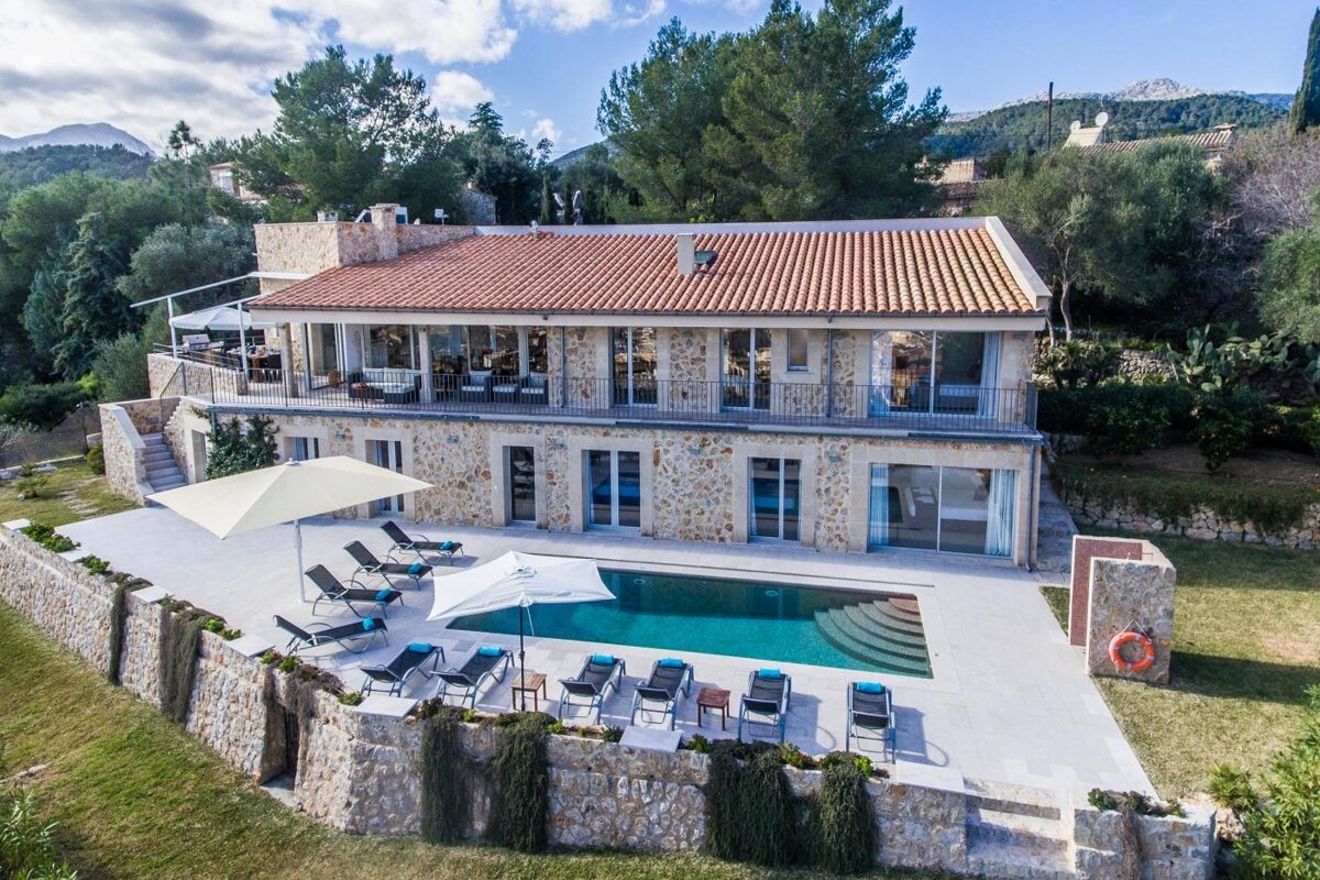 A large house with a large swimming pool in front of it