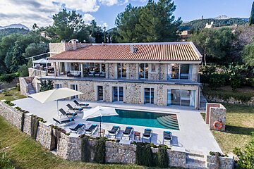 A large house with a large swimming pool in front of it