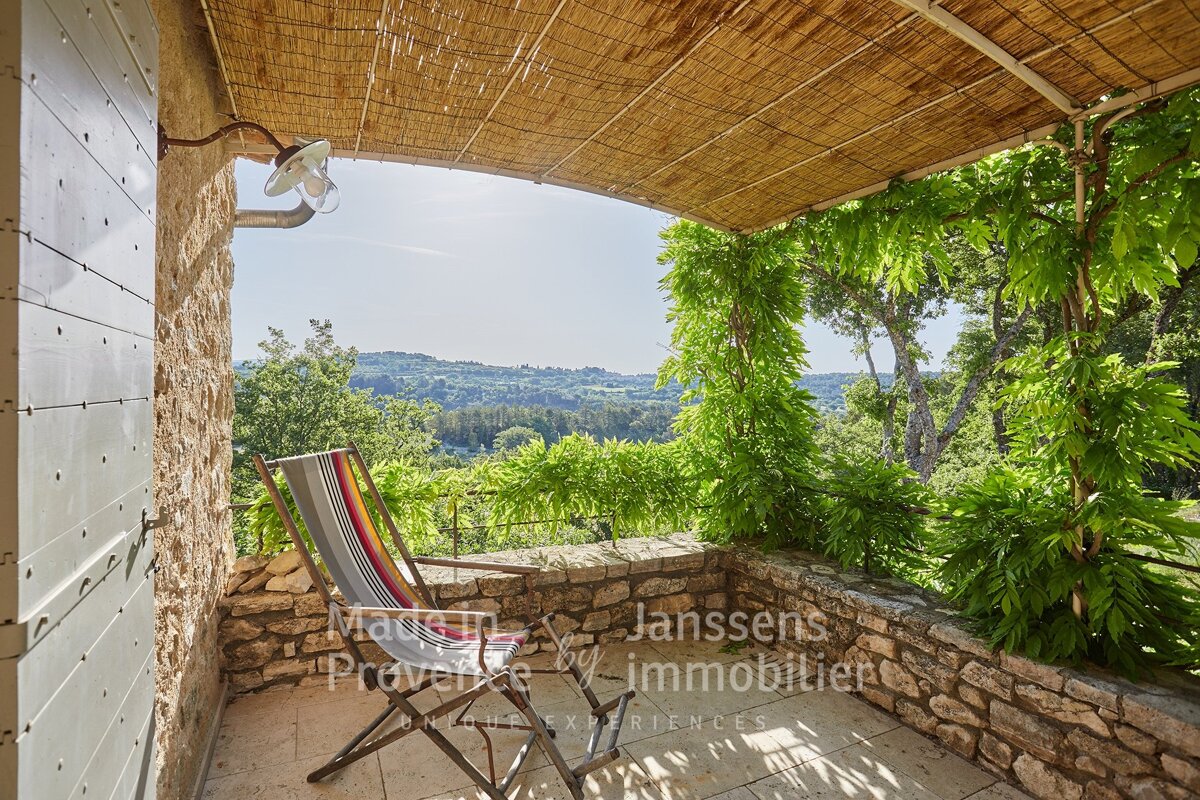A balcony with a chair and a sign that says janssens immobilier