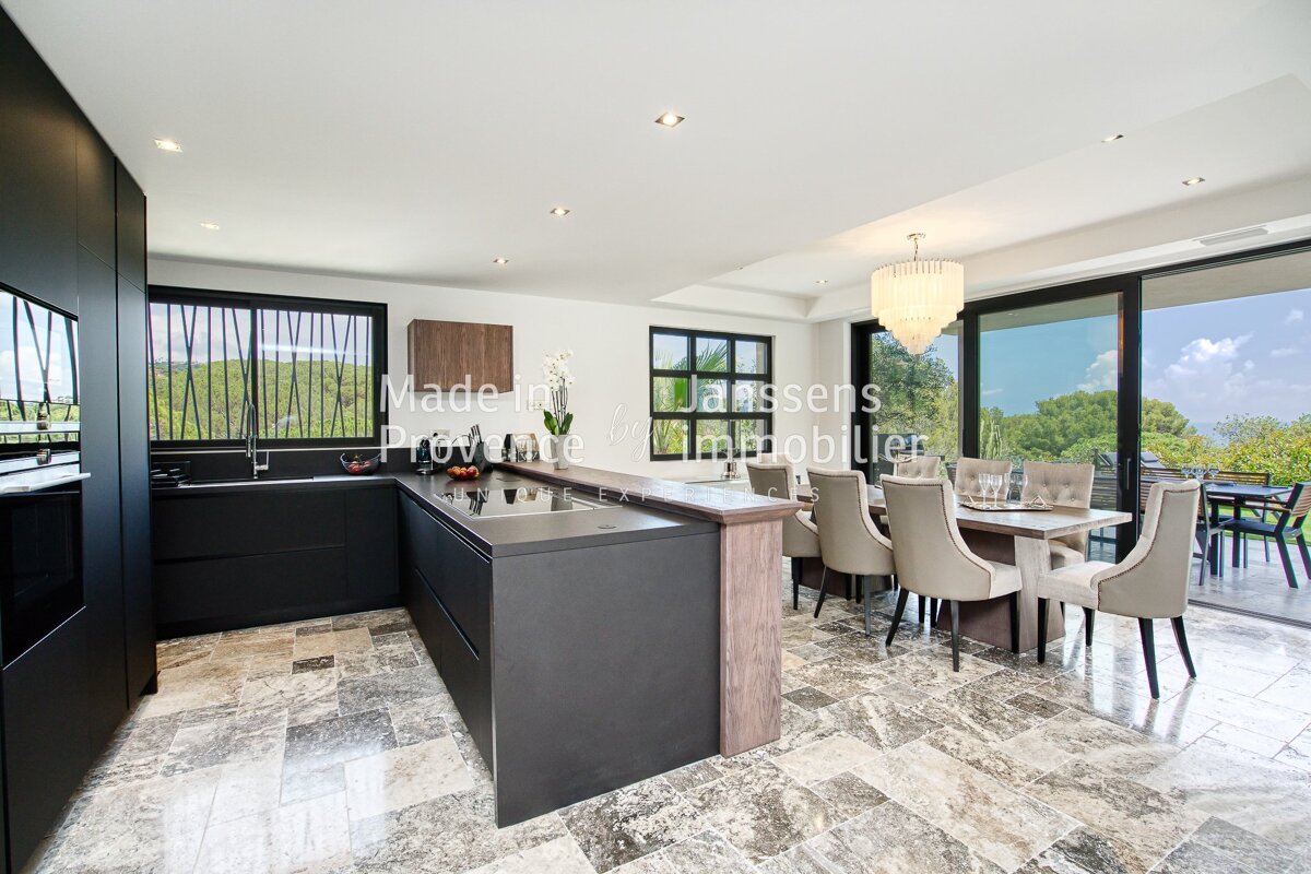 A kitchen and dining room with the word made on the bottom