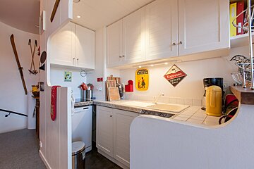 A kitchen with a sign on the wall that says espresso service