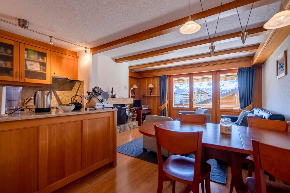 A living room with a dining table and chairs