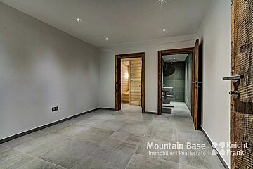 A room with a wooden door that says mountain base on it