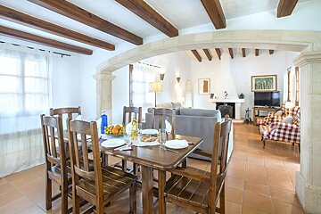 A living room with a dining table and chairs