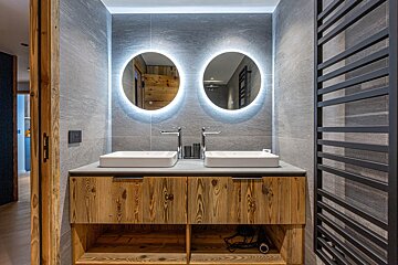 A bathroom with two sinks and two mirrors