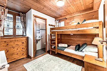 A bedroom with bunk beds and a dresser