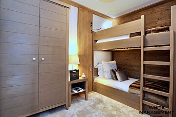 A bedroom with bunk beds and a sign that says renta design