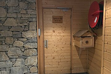 Rustic interior with a stone wall, wooden door to