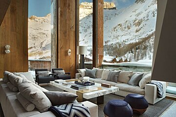 A living room with a view of a snowy mountain