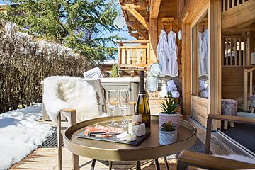 A table with a bottle of wine and two glasses on it